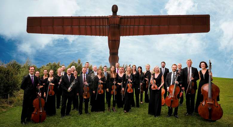 The Royal Northern Sinfonia stand under the Angel of the North