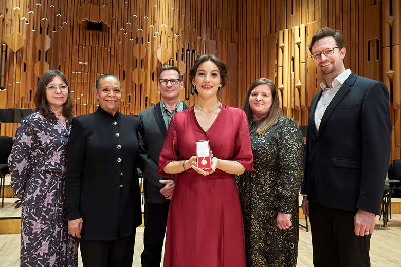 Alexandra Achillea Pouta accepts her medal with the competition's judges ©Clive Totman